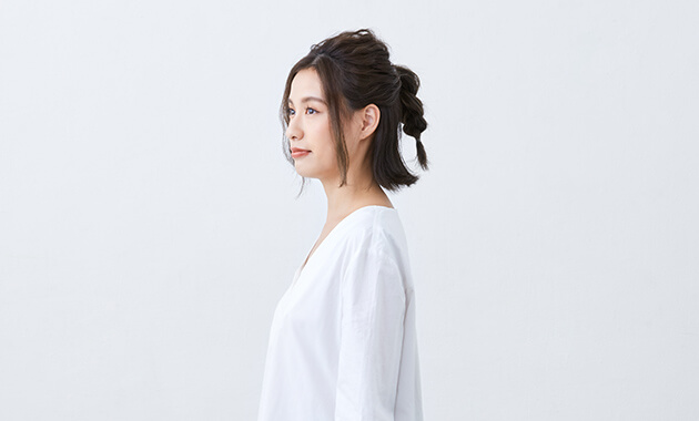 Triple-braided ponytail in profile 