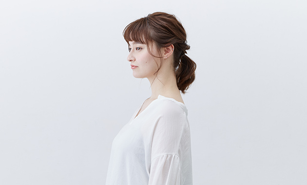 Low ponytail style in profile 
